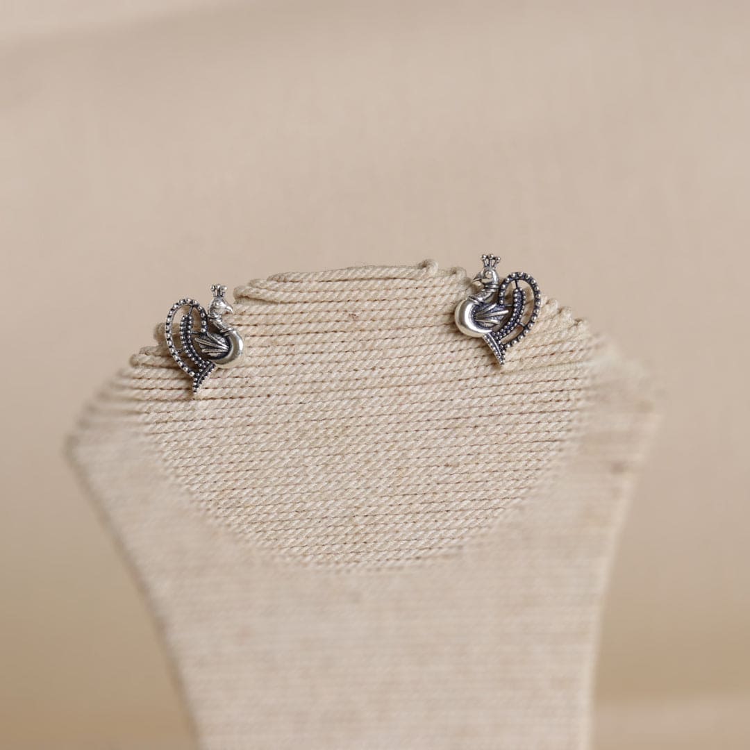 Embrace your inner allure with the exquisite Peacock Studds, handcrafted in sterling silver. These elegant earrings capture the essence of timeless beauty, perfect for enhancing your everyday style. Let their delicate design inspire confidence and self-expression, making each moment a celebration of your unique charm. Adorn yourself with these treasures, and step into a world where elegance meets empowerment.