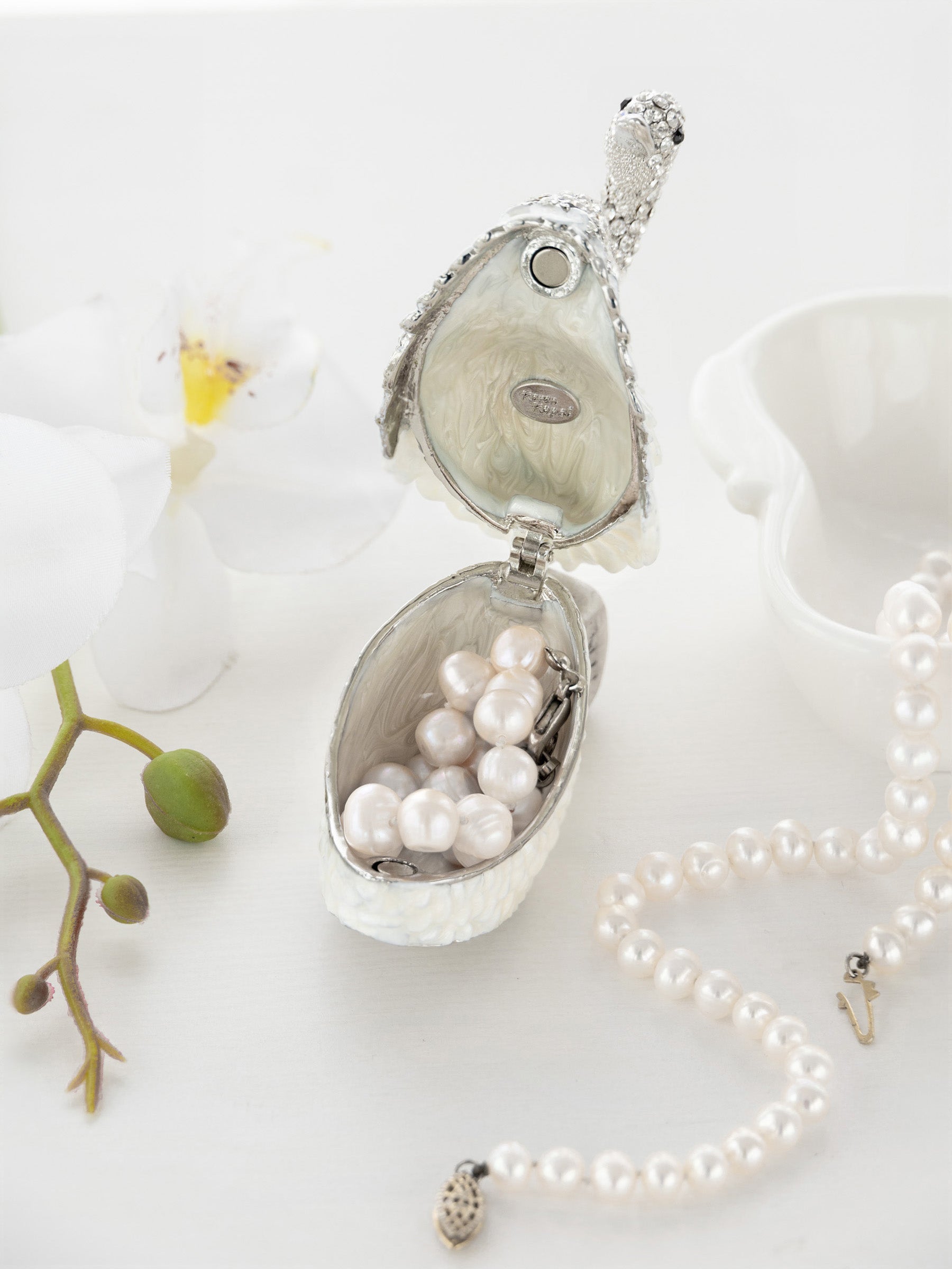 Embrace the allure of self-discovery with the Radiant White Swan with Crystals Neck Trinket Box. This exquisite piece, crafted with elegance and adorned with shimmering crystals, invites you to celebrate your unique beauty and freedom. Let it serve as a gentle reminder of the grace that resides within you, enhancing your space while embodying the rich symbolism of swans in various traditions. A perfect addition for those who cherish artistry and the deeper meanings of life.
