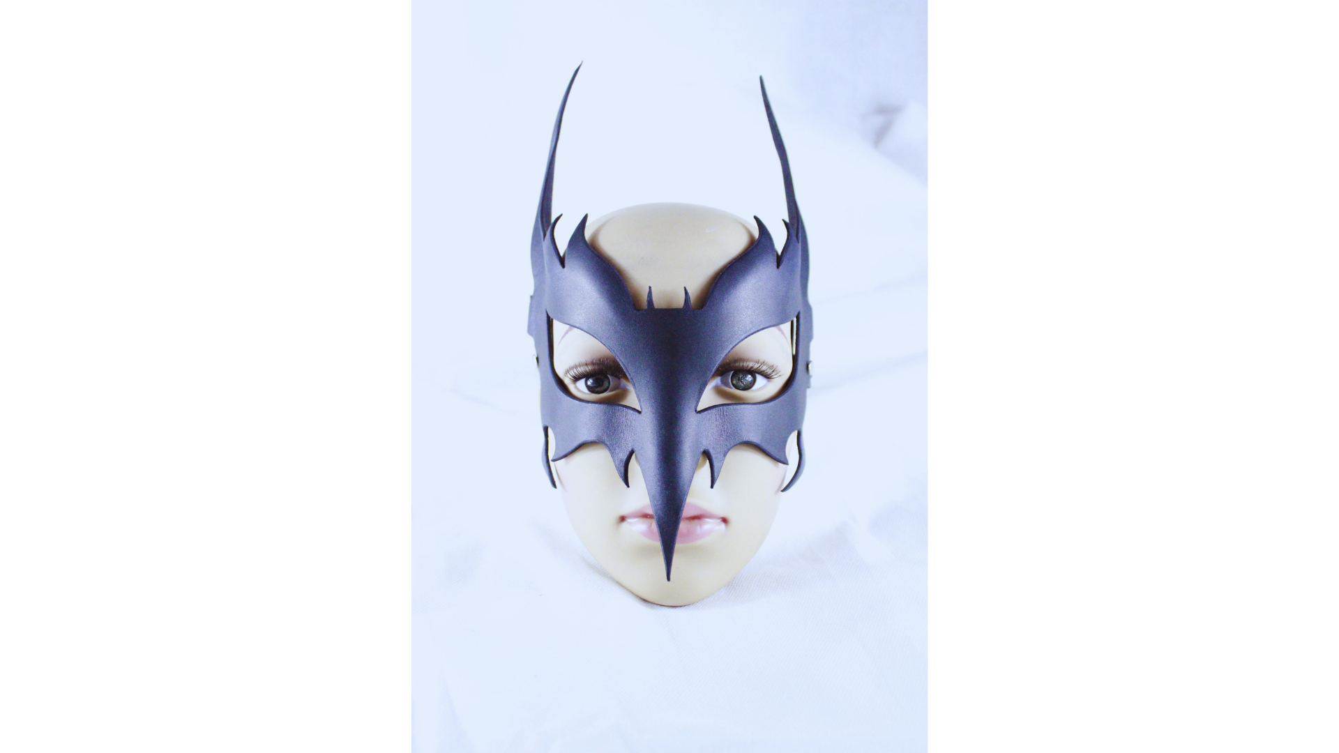 The Horned Leather Ritual Mask envelops you in an aura of mystique and power, inviting self-discovery and expression. Its elegant design, with elongated horns and subtle etching, transforms your presence into an icon of strength and allure. Embrace the beauty of control and the art of seduction as you wear this exquisite piece, perfect for ceremonial moments or expressive performances. Let it be a reflection of your unique journey, where darkness meets elegance, and every glance reveals a deeper story.