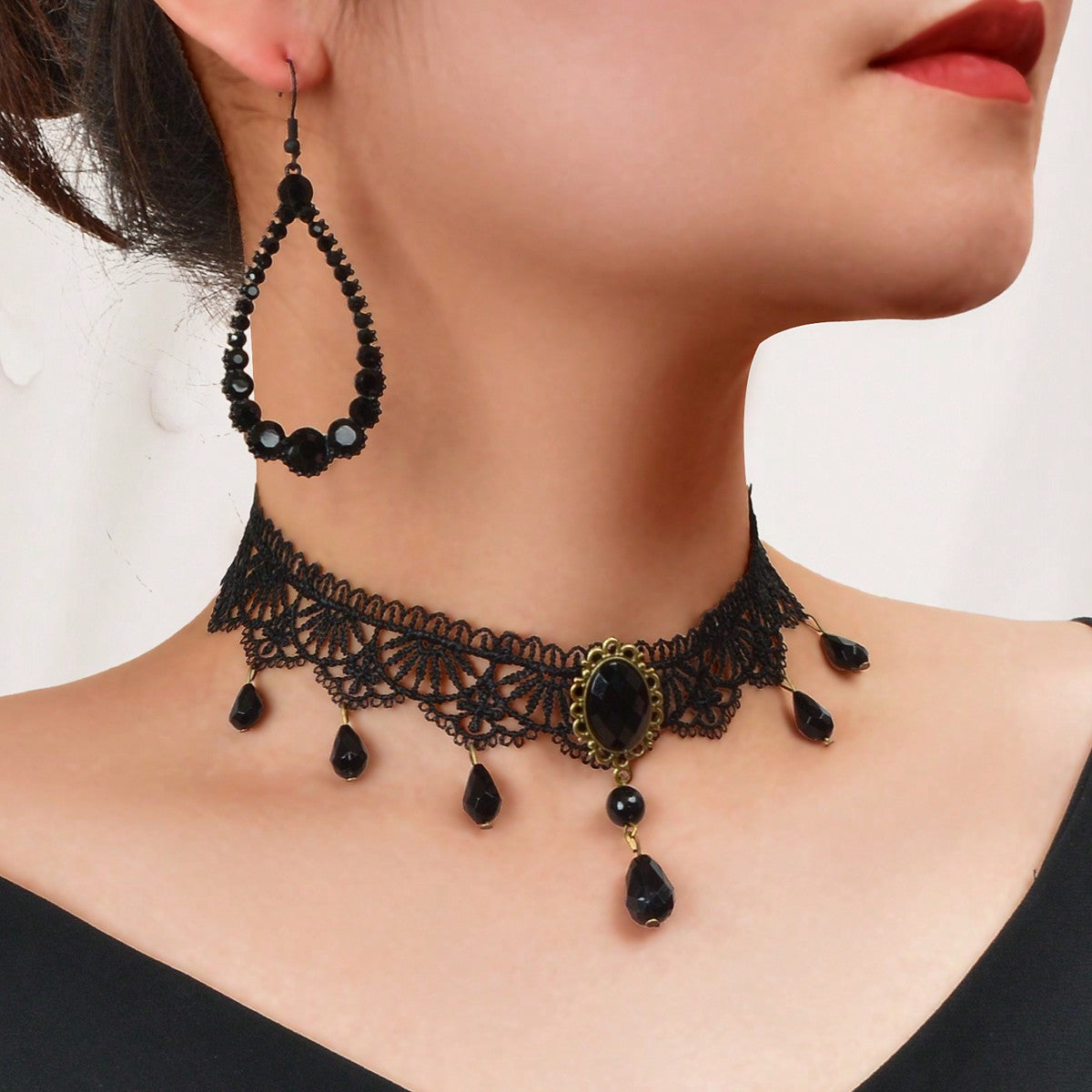 Embrace your elegance with this enchanting black lace choker and teardrop earrings set. Perfect for any occasion, it whispers sophistication and allure, inviting you to celebrate your unique beauty. Let the intricate lace and delicate beads enhance your style, empowering you to shine with confidence and grace.