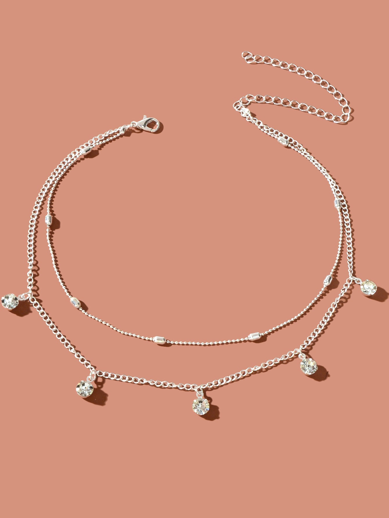 Embrace your inner elegance with the Dainty Adjustable Layer Gold Silver Chain Rhinestone Charm Clavicle Necklace. This exquisite piece, featuring a harmonious blend of gold and silver chains adorned with sparkling rhinestone charms, effortlessly enhances your neckline. Its adjustable design allows for a personalized fit, making it a perfect companion for any occasion. Celebrate your unique beauty and express your style with this enchanting necklace that radiates confidence and grace.