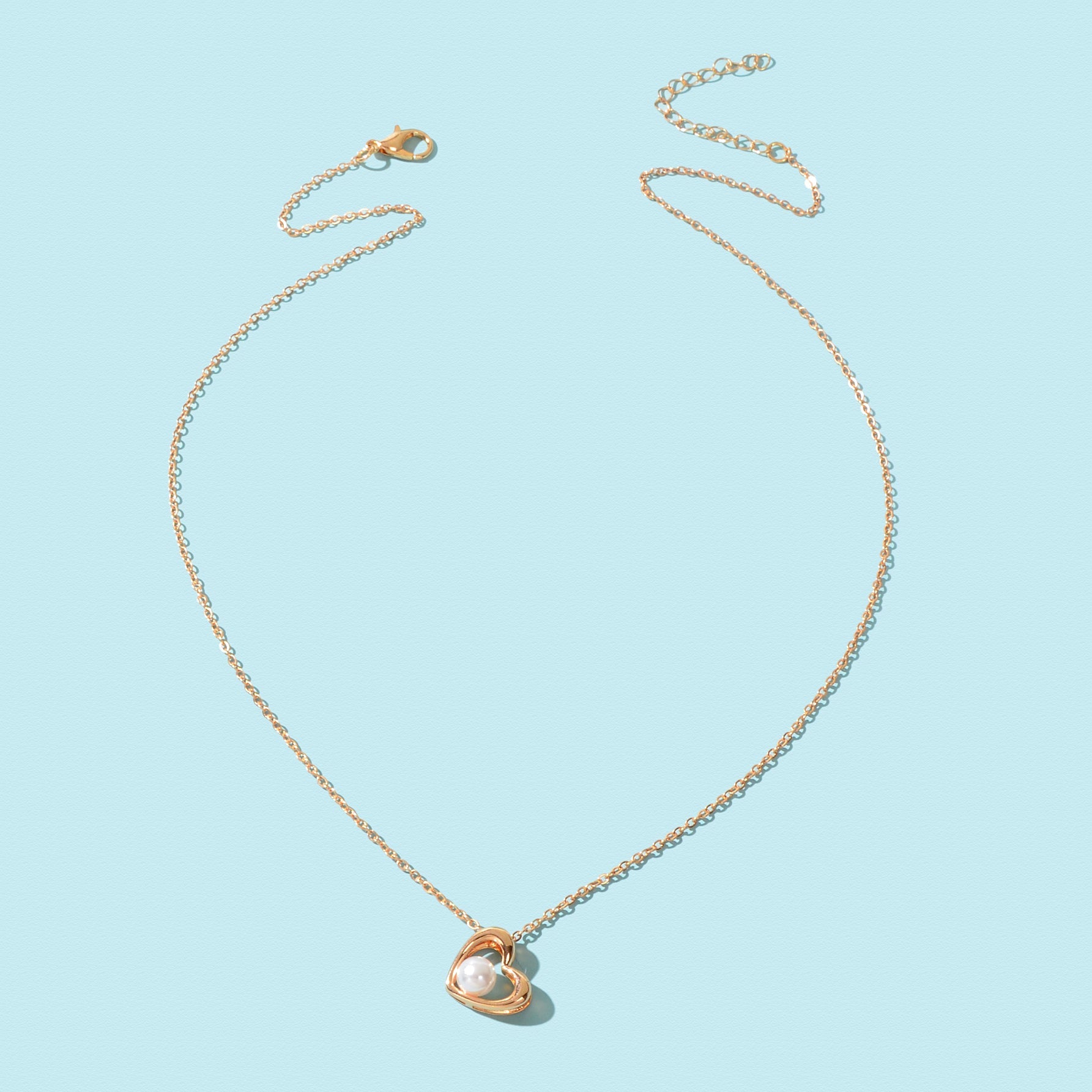 Embrace the elegance of everyday allure with this delicate golden chain necklace, adorned with a heart-shaped pendant and an enchanting imitation pearl. A perfect accessory for those who celebrate their unique beauty, this piece effortlessly enhances your style, whether at the office or out with loved ones. Gift it to yourself or someone special, and let it be a symbol of love and self-discovery.